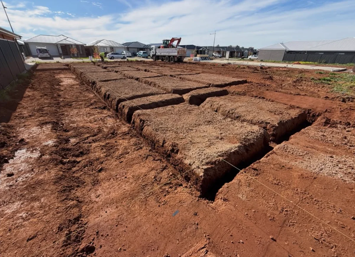 Large new-build estate block with a complete footing grid excavated and string lines set out